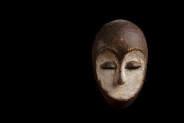 African mask from Gabon on a black background