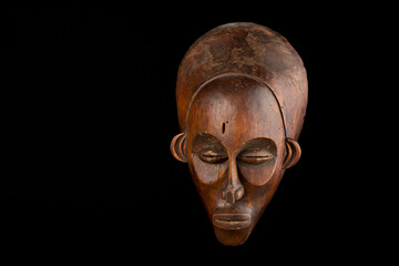 African mask on a black background