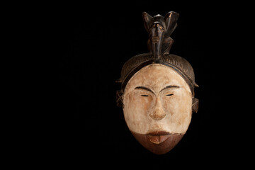 Fototapeta na wymiar African mask on a black background