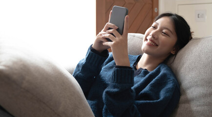 Portrait of smiling happy cheerful beautiful pretty asian woman relaxing making selfie photo on web...
