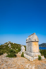 Naklejka premium Simena (Kalekoy) ancient ruin site with sarcophagus by historic Simena castle, Turkey by Kekova islands.