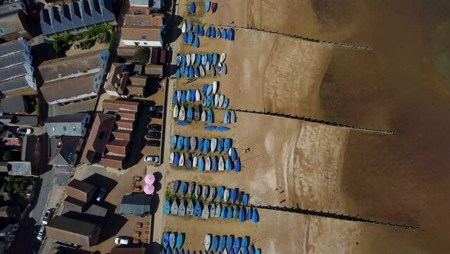 An birds eye view of the Whitstable beach, with the tide out showing yachts under covers.