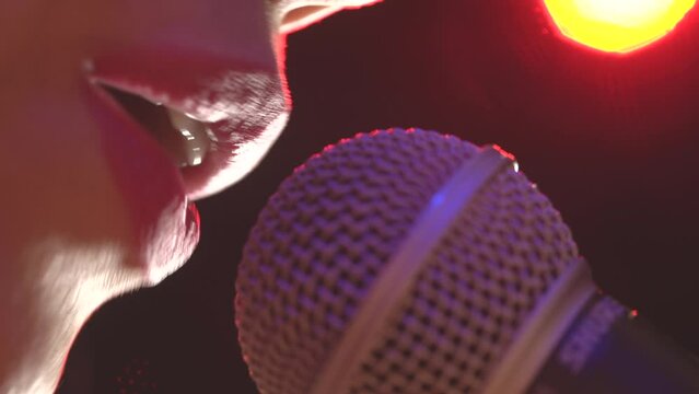 Woman sings to microfone extreme close up mouth