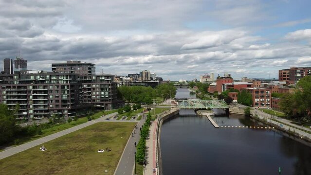 Montreal, Canada, camera panning, aerial drone view of canal Lachine, downtown Montreal, Griffintown area, neighborhood, buildings, Condominium, skyline, cityscape, buildings, skyscrapers