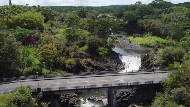 4K cinematic crane drone shot of two waterfalls in a tropical jungle near Hilo on the Big Island of Hawaii. This lush paradise scene was filmed using a DJI Mini 2 drone.