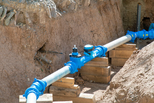 Construction site with blue supply pipes for water