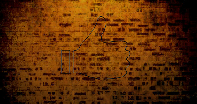 Image of glowing neon thumb up icon on brick wall