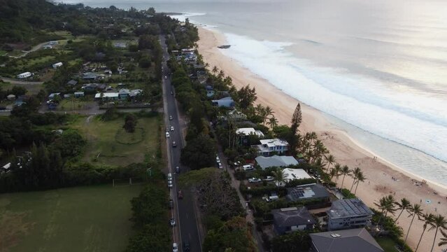 4K cinematic drone reveal shot of the beach at Banzai Pipeline on Oahu's North Shore during sunset. This stunning Hawaiian scene was filmed using a DJI Mini 2 drone.