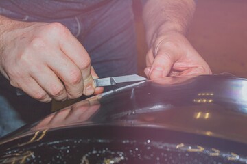 A close-up shows the process of installing PPF on the front headlight. PPF is a protective film for paint that protects the paint from scratches and stone chips. The concept of car body protection.	