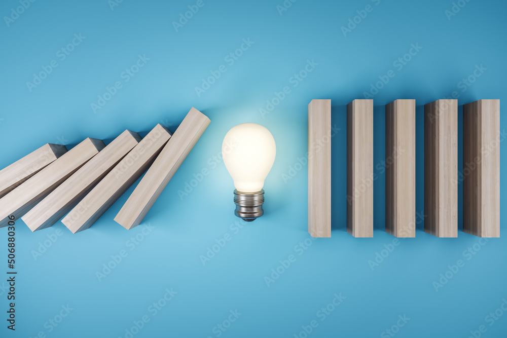 Poster business crisis and solution concept with switched on light bulb stopping wooden pieces of a domino 