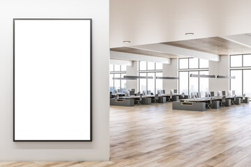 Front view on blank white poster in black frame in sunny coworking office with modern dark workspaces furniture, wooden ceiling and floor and city view from big windows. 3D rendering, mock up