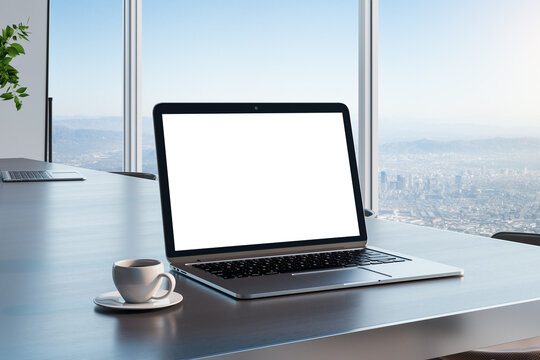 Blank white laptop screen with copyspace for your text on dark wooden table with coffee cup in sunny room and city skyline view from glass wall. 3D rendering, mockup