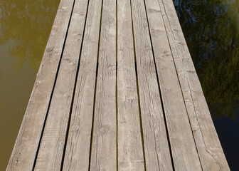 close horizontal photo of a wooden pier on the lake in sunny weather