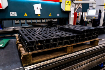 Special steel profile prepared in CNC machine stands in a heap. Selective focus profiles.