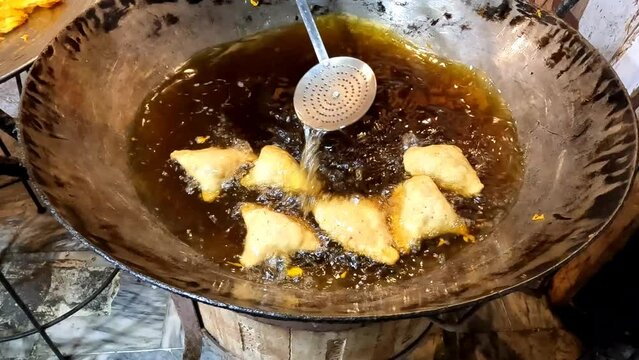 frying samosa in hot oil in pakistan streets 4k high resolution clip
