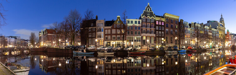 Panorama of the city waterfront of Amsterdam at sunset.