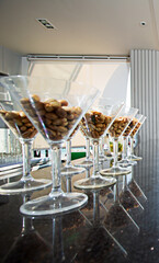 Peanuts in a glass are placed on the bar counter.