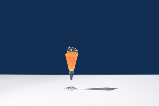 Orange tobiko caviar placed on cocktail glass with ice
