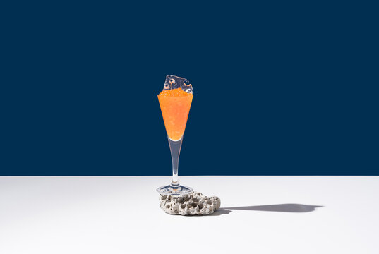 Orange tobiko caviar placed on cocktail glass with ice