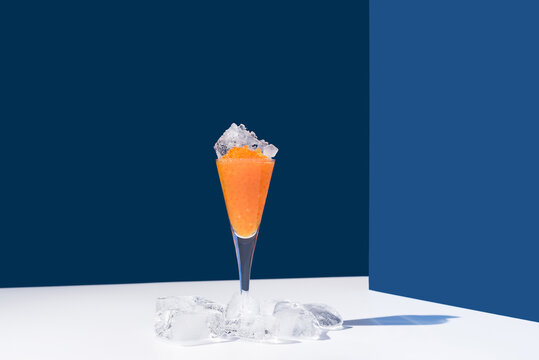 Orange tobiko caviar placed on cocktail glass with ice