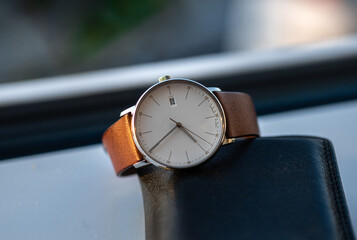Classic wrist watch with white dial and classic brown wrist band on leather