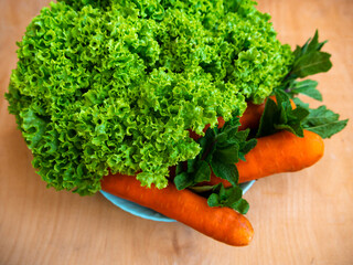 Fresh lettuce salad mint carrot plate on table top view. Sustainable living Shop local concept Farm...