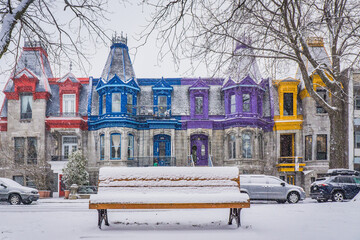 View on Carré Saint Louis colorful victorian houses on a snowfall day in Montreal, Quebec (Canada)