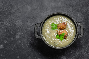 Mushroom creamy coconut soup on dark background. Top view, copy space.