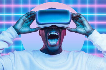 Shocked black gamer holding VR goggles to experience amazing and awesome metaverse virtual space