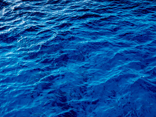 Close up of a calm water surface. Abstract nature background. Various shades of gray and blue.