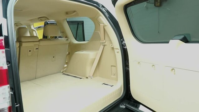 Close up shot  of back view of car empty space in the backside of car. Demonstrating the automatic liftgate. New function of the car. Technology and transportation concepts