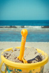 Plastic bucket with showel using for relax and playing at beach. Summer, vacation time and child development