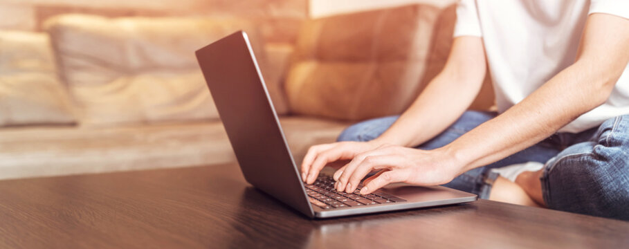 Girl  sitting home working and browsing online on laptop.