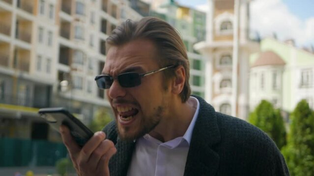 Unsatisfied CEO yelling at manager on cell phone for unsatisfactory results in the company. Frustrated wealthy top executive arguing on the phone and screaming at employee. Boss shouting on mobile

