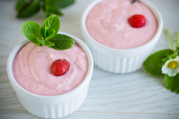 sweet curd mass whipped with fresh strawberries in a bowl