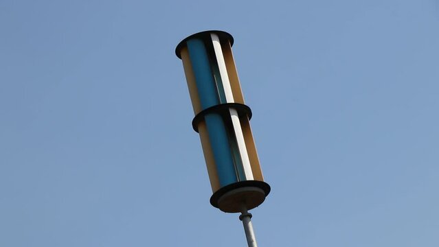 Vertical axis Wind generator or a wind turbine in working condition on a day with blue sky in the background