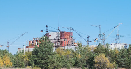 View of the unfinished reactor in Chernobyl. Cranes over a nuclear power plant. Abandoned...