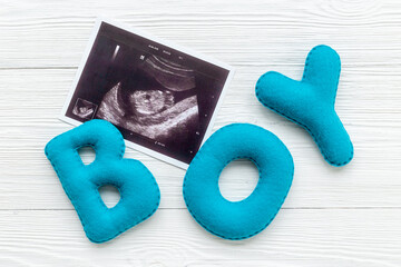 Ultrasound scan of unborn baby with letters boy