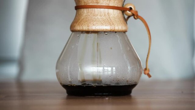 Freshly Brewed Coffee Dripping Inside A Pour Over Glass Coffeemaker On The Table. close up