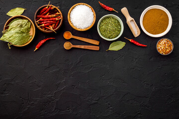 Powdered spices and herbs in bowls. Colorful cooking background