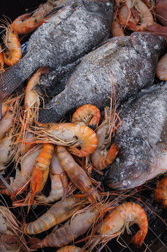 Fish And Shrimp Are Being Burned On The Charcoal Stove.