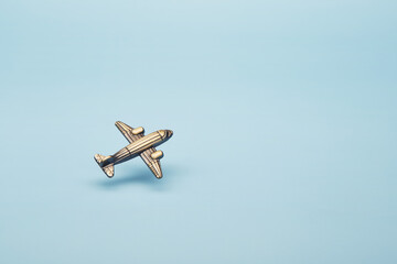 Small toy airplane vintage classic old school style model isolated on the bright solid blue fond...