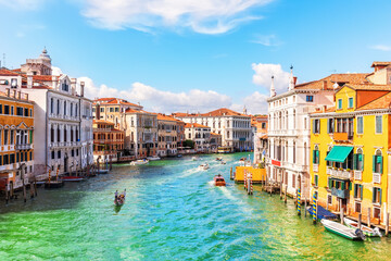 Fototapeta na wymiar Channel of Venice with luxurious houses, gondolas and boats, Italy