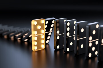 Unique yellow glowing domino tile among many black dominoes