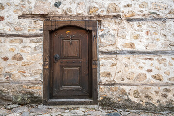 Fototapeta na wymiar Ancient wooden door in stone castle wall