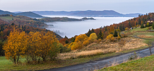 Foggy early morning autumn mountains scene. Peaceful picturesque traveling, seasonal, nature and countryside beauty concept scene. Carpathian Mountains, Ukraine.
