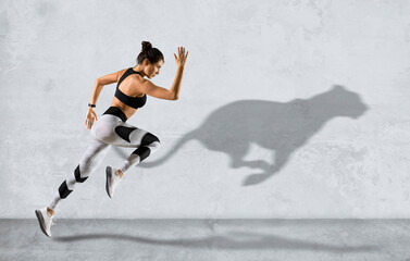 Sporty woman running on grey wall background wearing in sportswear - 506910719