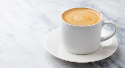 Coffee, espresso in white cup. Marble table background. Close up. Copy space.