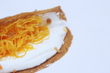 Thai Food, Thai Crispy Pancakes served in a black plate on a brown wooden table.