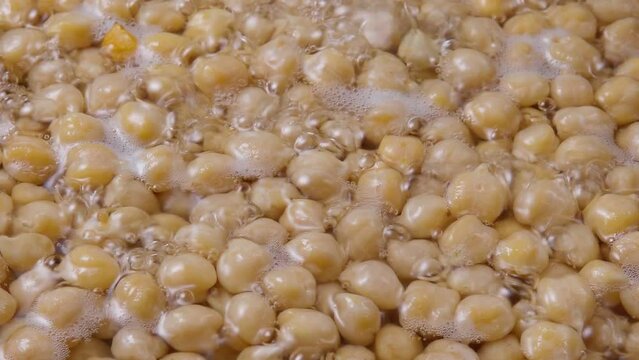 Chickpeas legumes in water. Vegan cooking. Prepare chickpeas before making hummus and other legume dishes.